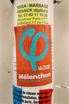 A poster for "La France Insoumise" with the name "Mélenchon" is placed on a pole. Above it, an advertisement for a yoga/massage therapist named Franck, detailing his availability in the 17th Paris district. Text in blue at the bottom is partially visible, indicating an ongoing campagne in Paris.