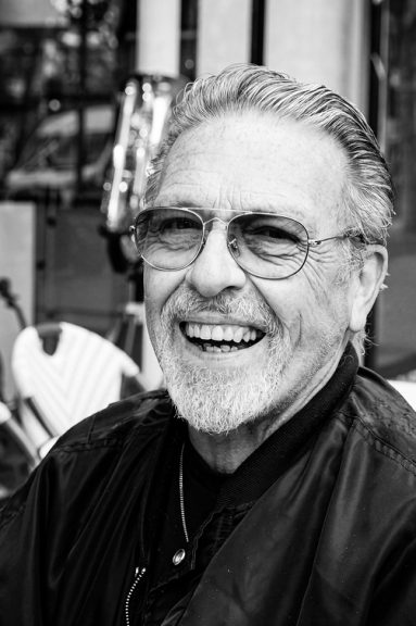 Black and white portrait of Jean Benoit Roubinet, a smiling older man with a goatee and spectacles.